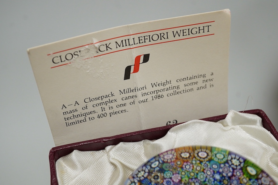 Two boxed Perthshire glass paperweights, the first faceted with latticino twists and complex canes, the second close packed millefiori paperweight, 62/400
